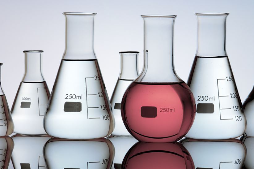 group of laboratory flasks containing liquid color