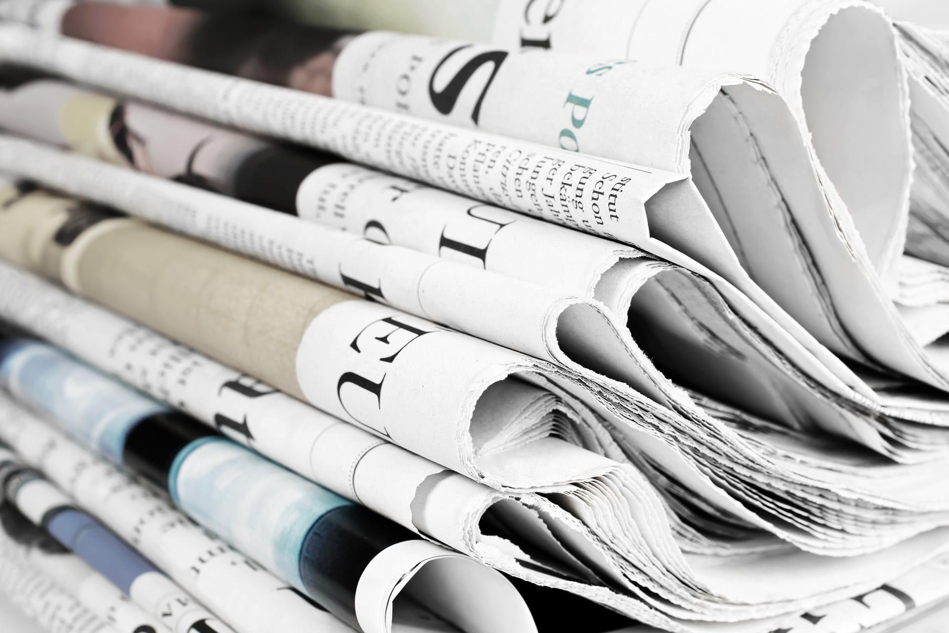 Stacks of different daily newspapers