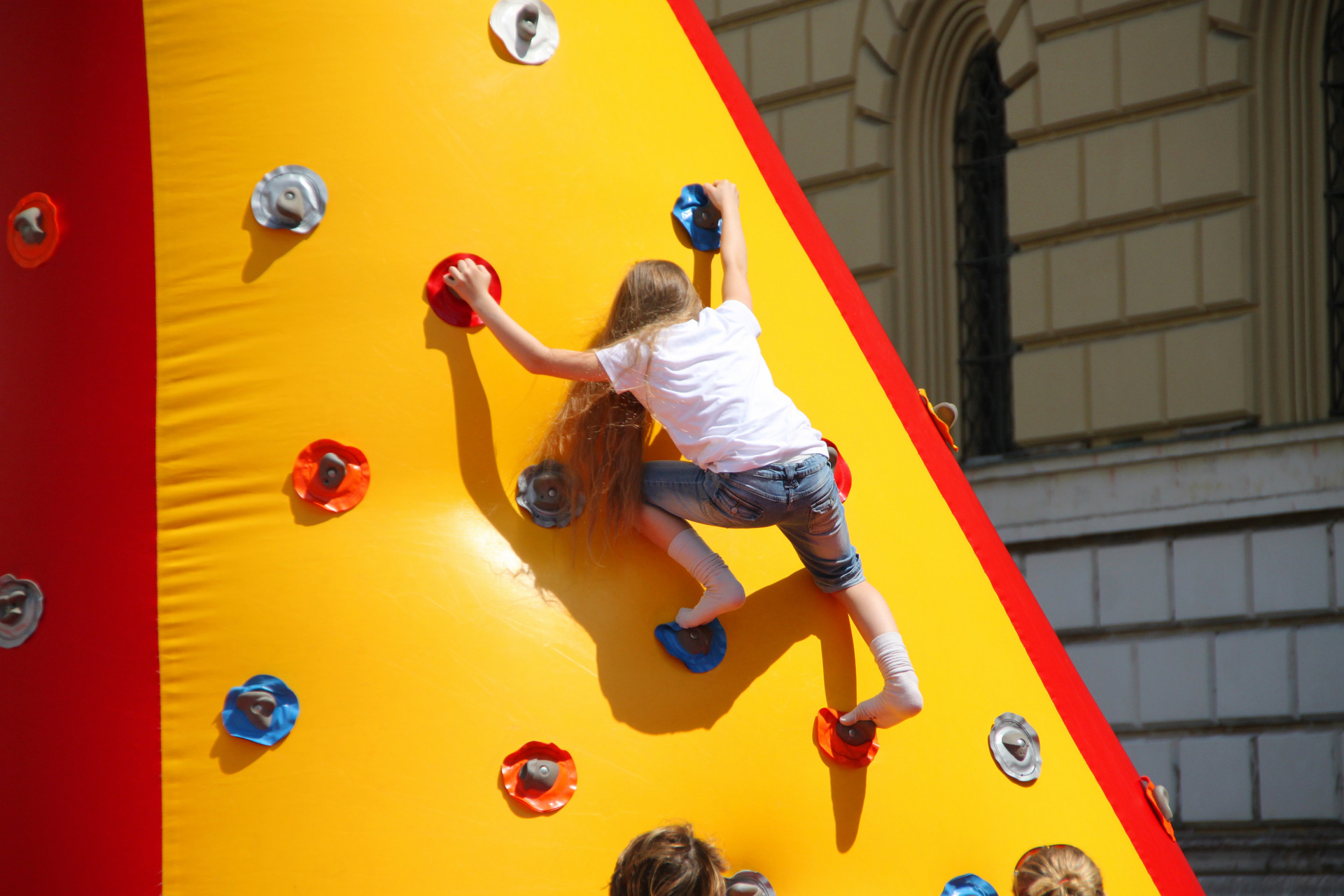 Girl climbing an inflatable climbing wall