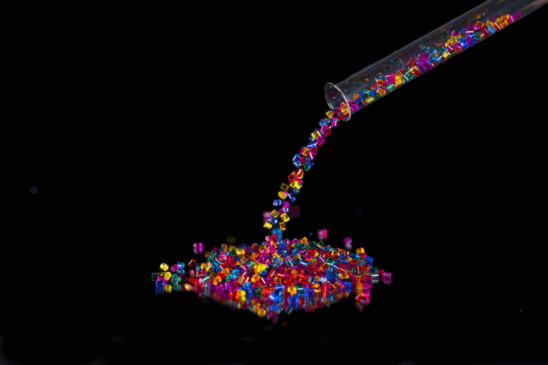 Colorful Macrolex granules are poured from test tube