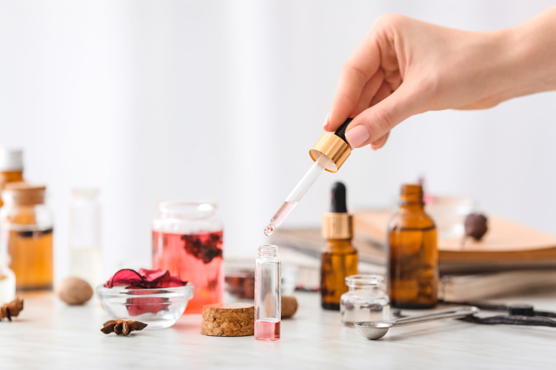 Woman preparing perfume on table