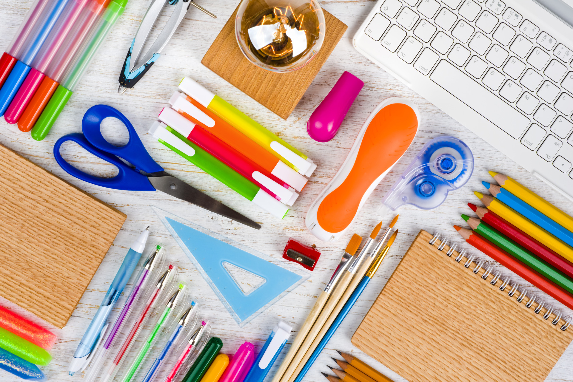 Above view of school and office supplies on wooden table