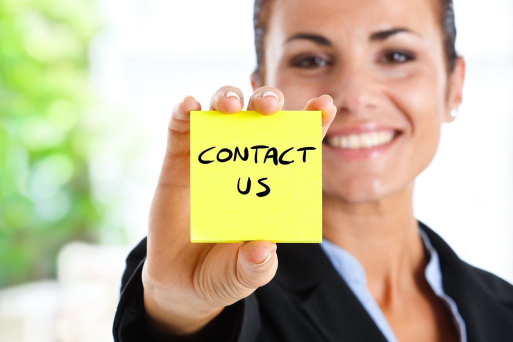 Businesswoman showing &quot;contact us&quot; text on a post-it