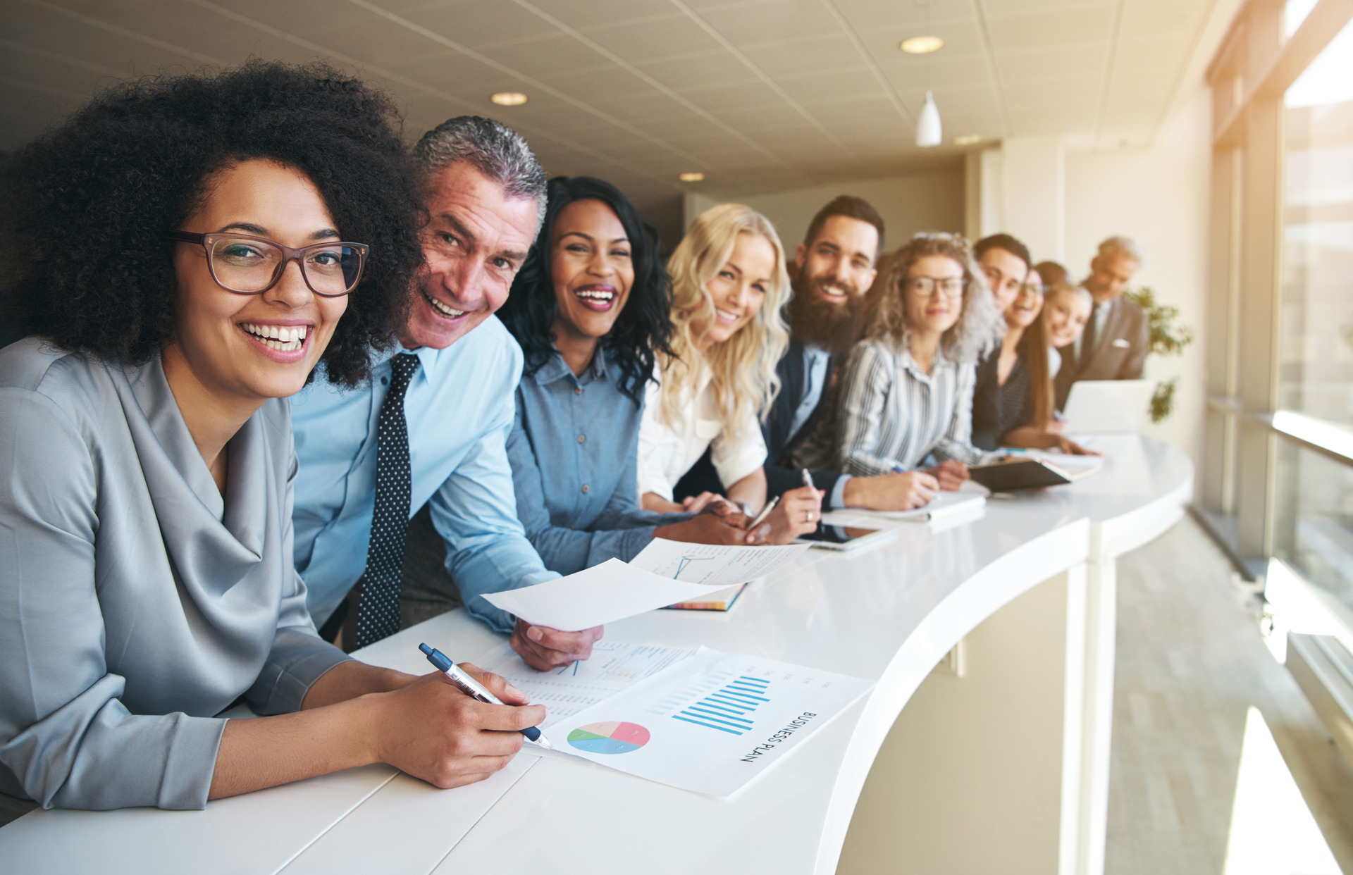 Smiling black coworkers looking at the camera in the office.