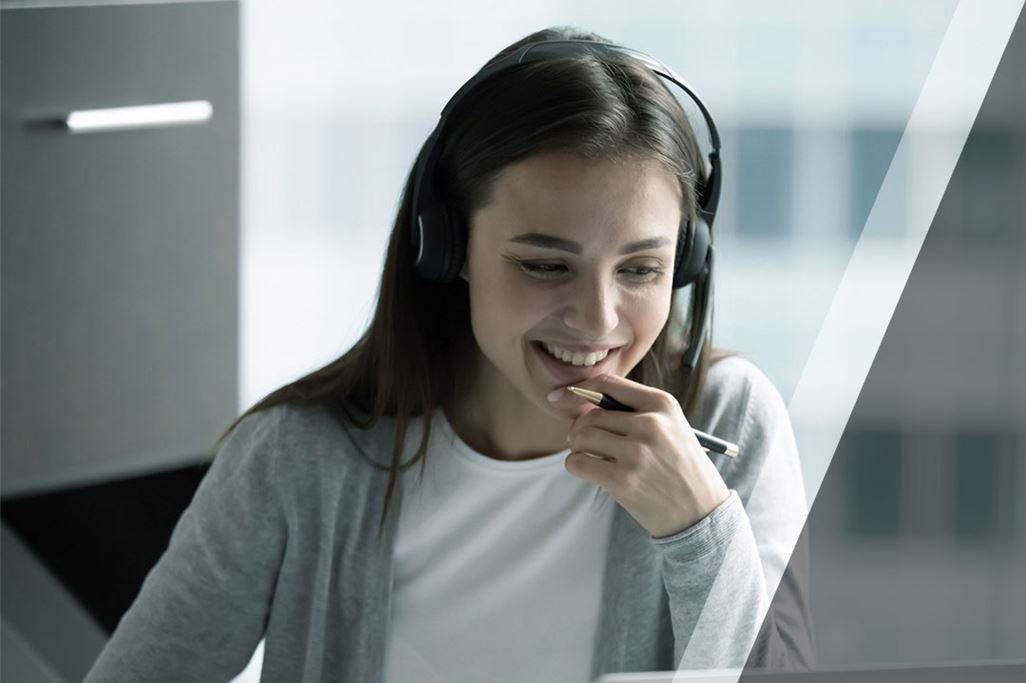 Smiling female employee in headphones have video call