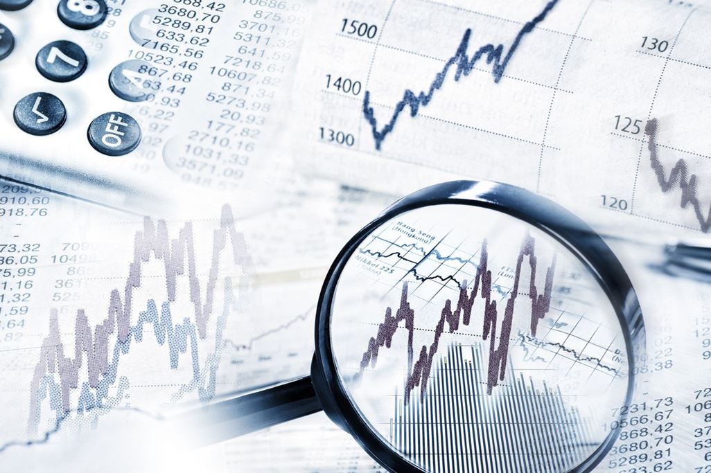 Stock quotes as graph and table with magnifying glass and calculator in panorama format