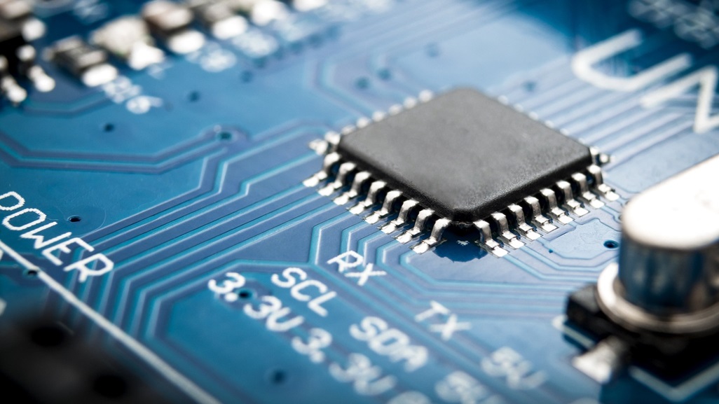 Integrated semiconductor microchip/ microprocessor on blue circuit board representative of the high tech industry and computer science