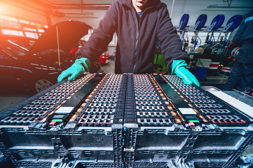 Disassembling the battery of an electric vehicle engine.