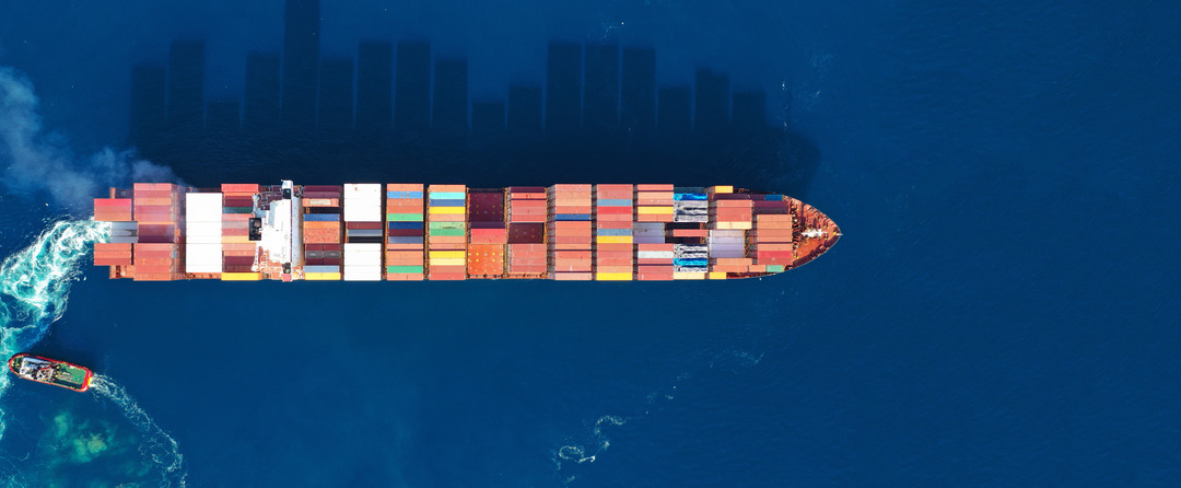 Aerial drone photo of industrial cargo container carrier cruising the open ocean deep blue sea