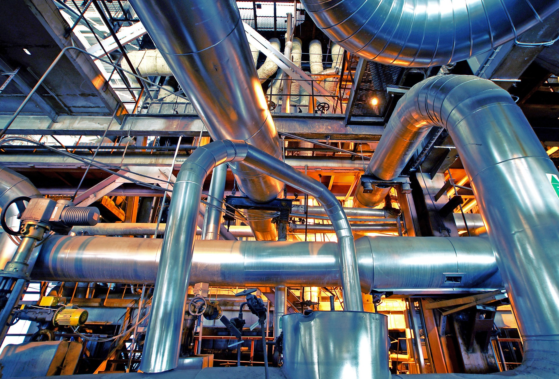 Equipment, cables and piping as found inside of a modern industrial power plant.