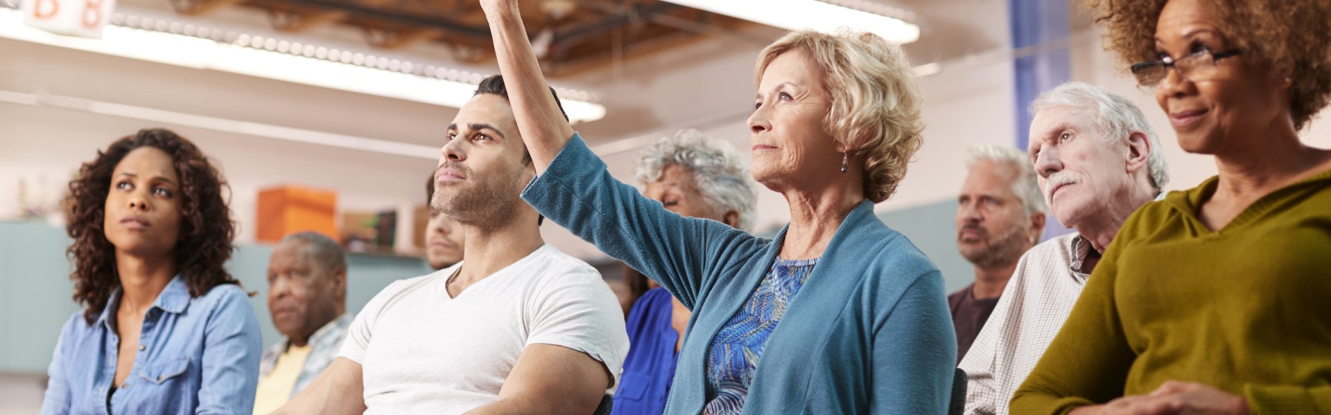 Woman Asking Question At Neighborhood Meeting In Community Center