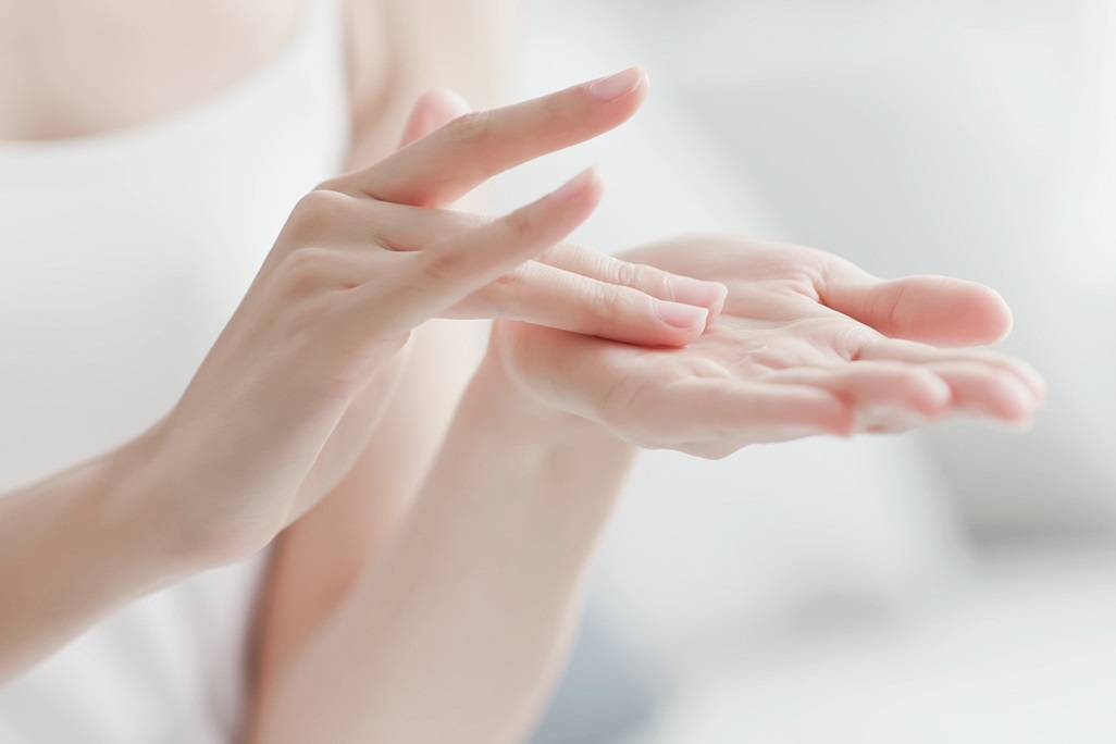 Woman apply moisturizer in hand