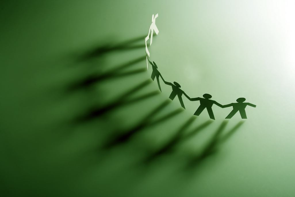 Group of male paper chain representing teamwork.