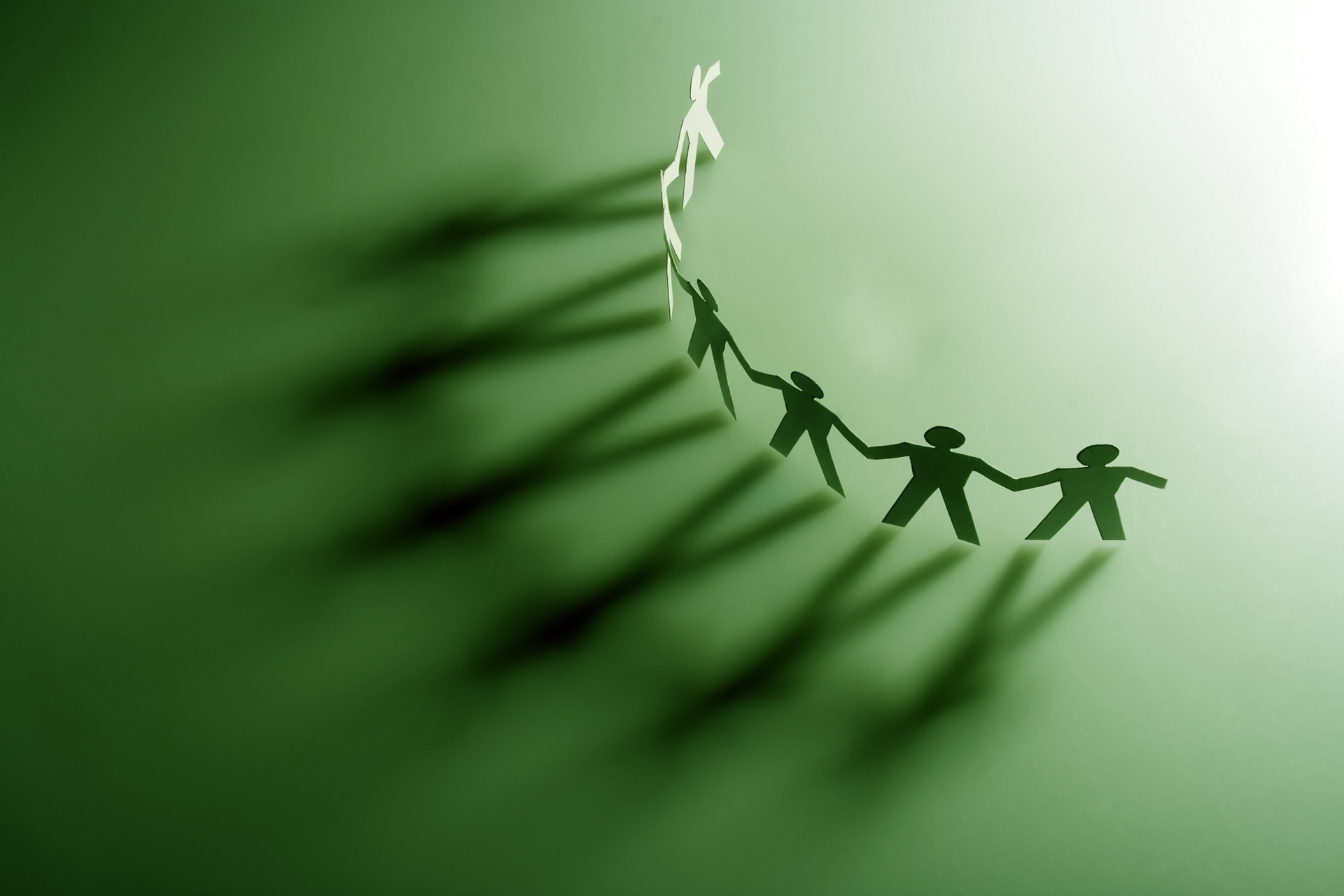 Group of male paper chain representing teamwork.