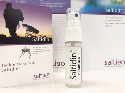 Saltidin sample bottle in front of Saltidin catalogs. It is used to explain general explanation of Saltidin (Icaridin) as part of Search Engine Explanation (SEO)