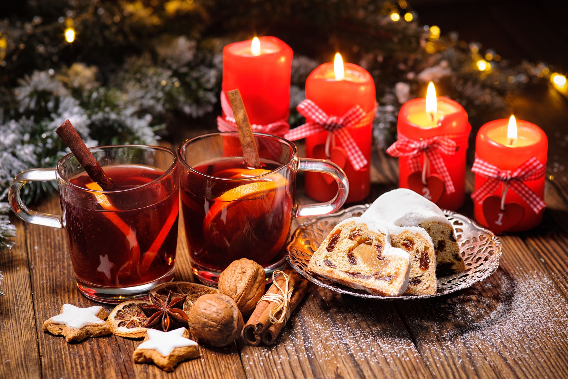 Christmas mulled wine on table with burning advent candles and christmas decorations