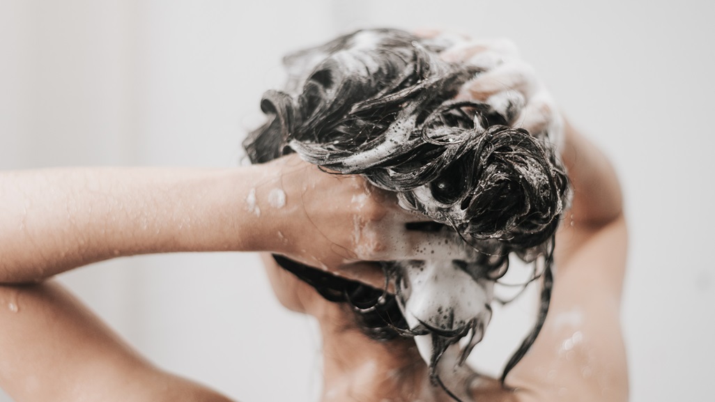 Woman washing hair with shampoo and shower in bathroom, Asian female body and hair care with foam to freshness. Spa and Health care.